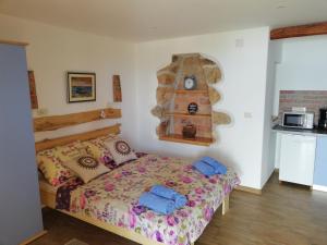 a bedroom with a bed and a clock on the wall at Apartments Blue & Green in Mošćenička Draga