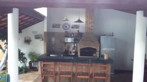 a kitchen with a stove and a fireplace at Hospedaria Chez Nous in Caucaia