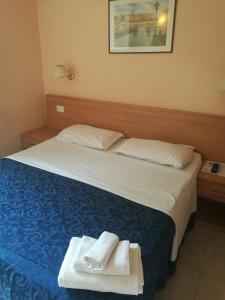 a hotel room with a bed with towels on it at Palma Residence in Rome