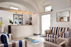 a living room with two chairs and a table at Villa delle Palme in Santa Marinella