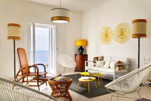 a living room with a couch and chairs at Villa delle Palme in Santa Marinella