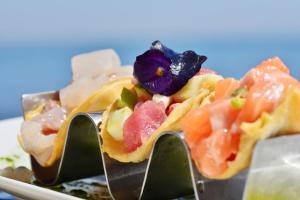 a plate of food with a purple flower on top at Villa delle Palme in Santa Marinella