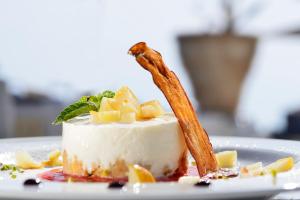a piece of cake with a stick on a plate at Villa delle Palme in Santa Marinella