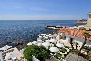 a view of a beach with umbrellas and the ocean at Villa delle Palme in Santa Marinella