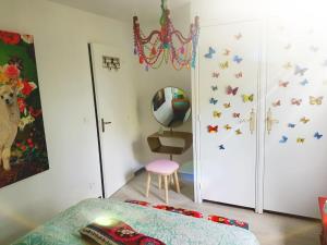a bedroom with a bed and a closet with butterflies on the wall at Maison Lolly corse wifii free in Borgo