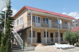 a house with a staircase on the side of it at Адилет in Cholpon-Ata
