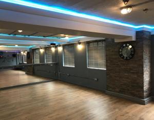 a dance floor with a clock on the wall at Cumberland Hotel - OCEANA COLLECTION in Bournemouth
