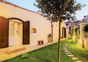 a house with a tree in the yard at Borgo San Gaetano in Bernalda