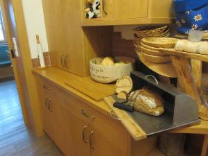 a kitchen counter with some bread and a cutting board at Familienbauernhof Christa in Rossleithen