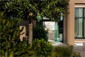 a tree in front of a building at Tresor Le Palais Timisoara, Curio Collection by Hilton in Timişoara