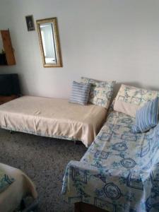 a bedroom with two beds and a mirror at Casa Vacanze S.Maria di Leuca in Leuca