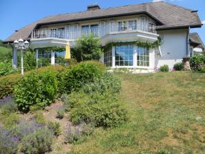 a house on top of a hill with flowers at Zur Gartenlaube in Bullay