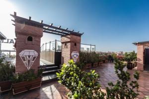 a patio with a brick building and a bird house at Hotel Almas in Marrakesh