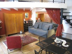 a living room with a couch and a table at StellaHome - La petite cour in Sanary-sur-Mer