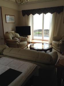 a living room with a couch and a table at B&B at 37 in Anstruther