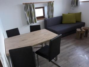 a living room with a table and a couch at Appartement Wildkogelblick in Neukirchen am Großvenediger