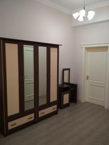 a room with a large wooden cabinet and a mirror at Hotel Elita in Odesa