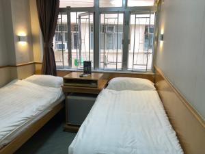 Postel nebo postele na pokoji v ubytování Good Fortune Inn