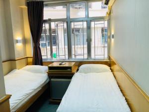 Postel nebo postele na pokoji v ubytování Good Fortune Inn