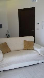 a white couch with two pillows sitting in a room at Residence Mirage Milazzo in Milazzo