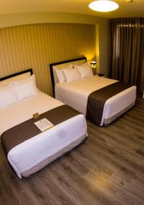 Postel nebo postele na pokoji v ubytování LimaQ Hotel