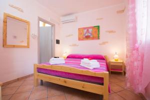 Postel nebo postele na pokoji v ubytování B&B La Baita Del Sud