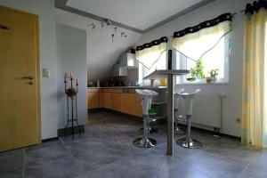 a kitchen with a table and stools in a room at Ferienwohnung Henry im schönen Allgäu in Westendorf