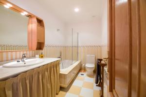 a bathroom with a sink and a tub and a toilet at Andares in Arzúa +17 photos