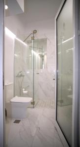 a bathroom with a shower and a toilet and a sink at Best of Athens Apartment in Athens
