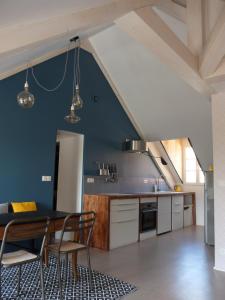 a kitchen with a table and chairs in a room at Le Jardin De Gustave in Ornans +41 photos