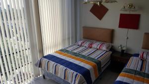 a small bedroom with a bed and a window at Apartment business/airport area Guatemala City in Guatemala