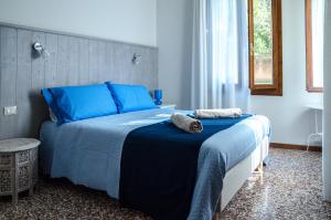 a bedroom with a blue bed with towels on it at Appartamento Azzurro Two Bathrooms in Venice