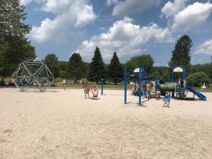 a group of people playing on a playground in the sand at Vakantiewoning Duitsland in Freisen