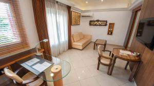 a living room with a glass table and chairs at Nomad Suites Residence in Libreville