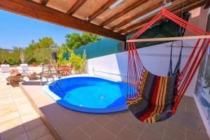 a patio with a swing and a swimming pool at Vila Izabela in Stara Novalja
