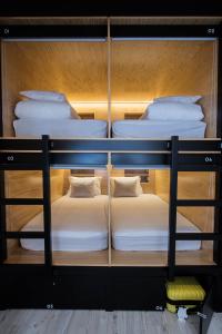 two bunk beds sitting on top of a room at GiG Capsule Hostel in Ericeira