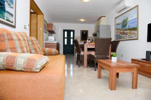 a living room with a couch and a table at Apartment Markioli in Povlja