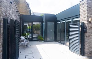 an extension to a house with glass doors and a patio at Gillespie House in Edinburgh