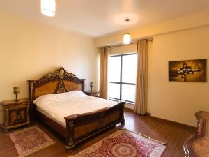 a bedroom with a large bed and a window at JBR, Bahar 1 in Dubai