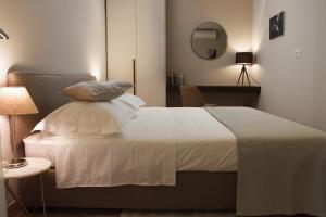 a bedroom with a bed with white sheets and pillows at Luxury Poolside Villa in Slatine +39 photos