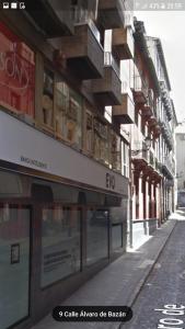 a building with windows on the side of a street at Apartamento GranVía4 Parking free in Granada
