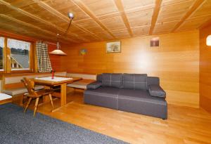 a living room with a couch and a table at Bauernhof Madlener Claudia in Schoppernau