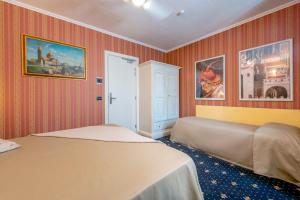 Postel nebo postele na pokoji v ubytování Holiday Rooms Antica Badia