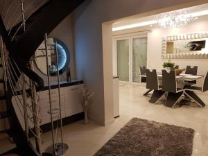 a dining room with a staircase and a dining table at Haus am Jachthafen in Werder