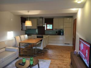 a living room and kitchen with a table and a couch at Naturresidenz Kropfitsch in Krumpendorf am Wörthersee