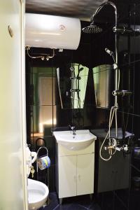 a small bathroom with a sink and a mirror at Къща за гости "Черната роза" in Bŭlgarevo +26 photos