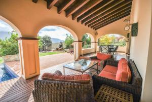 an outdoor patio with couches and a glass table at Mirador del Torcal in Antequera