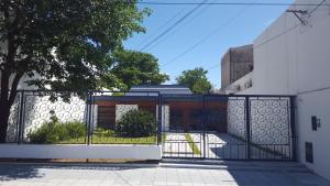 a gate in front of a building at La Maison in San Fernando del Valle de Catamarca