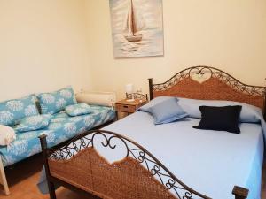 a bedroom with a bed and a couch at Casa di Chiara in Villasimius