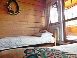 a bedroom with two beds in a room with a window at Pokoje u Kalaty in Szaflary